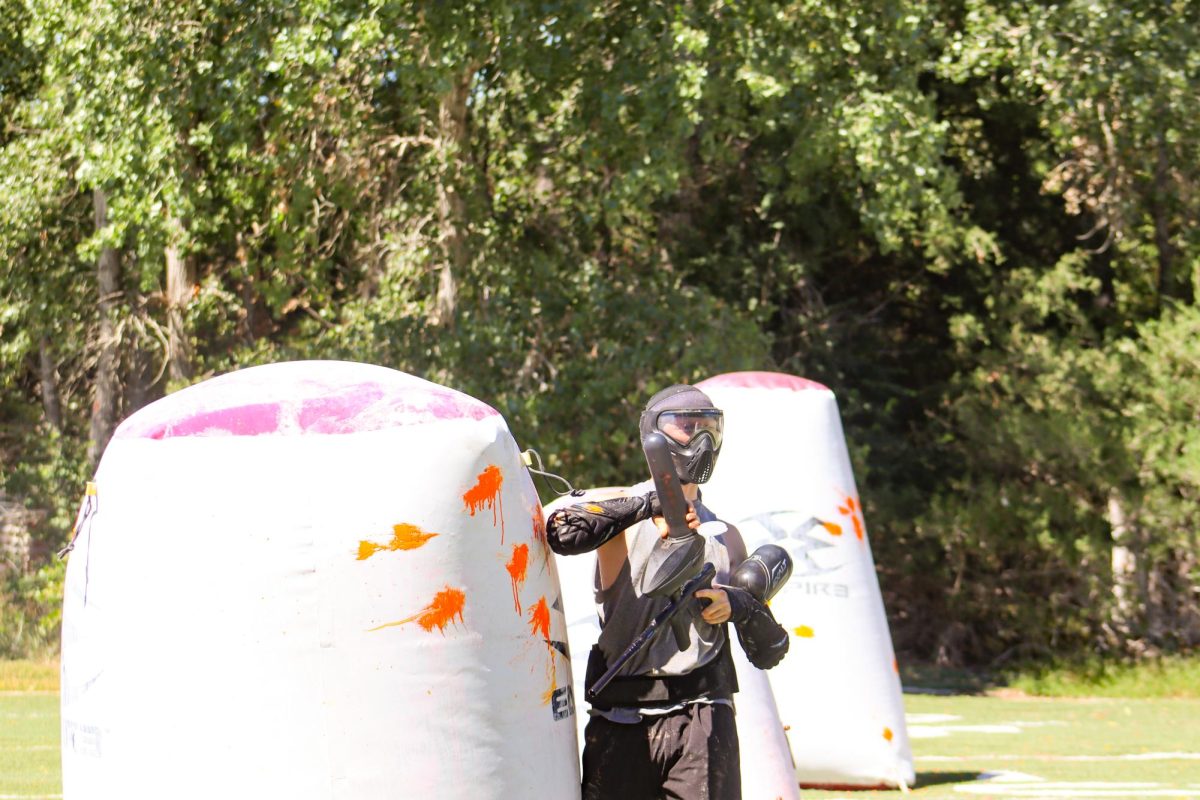 Senior Tanner Radford reloads his paintball marker, also known as a gun. The club has seen a significant increase in interest from people wanting to join.