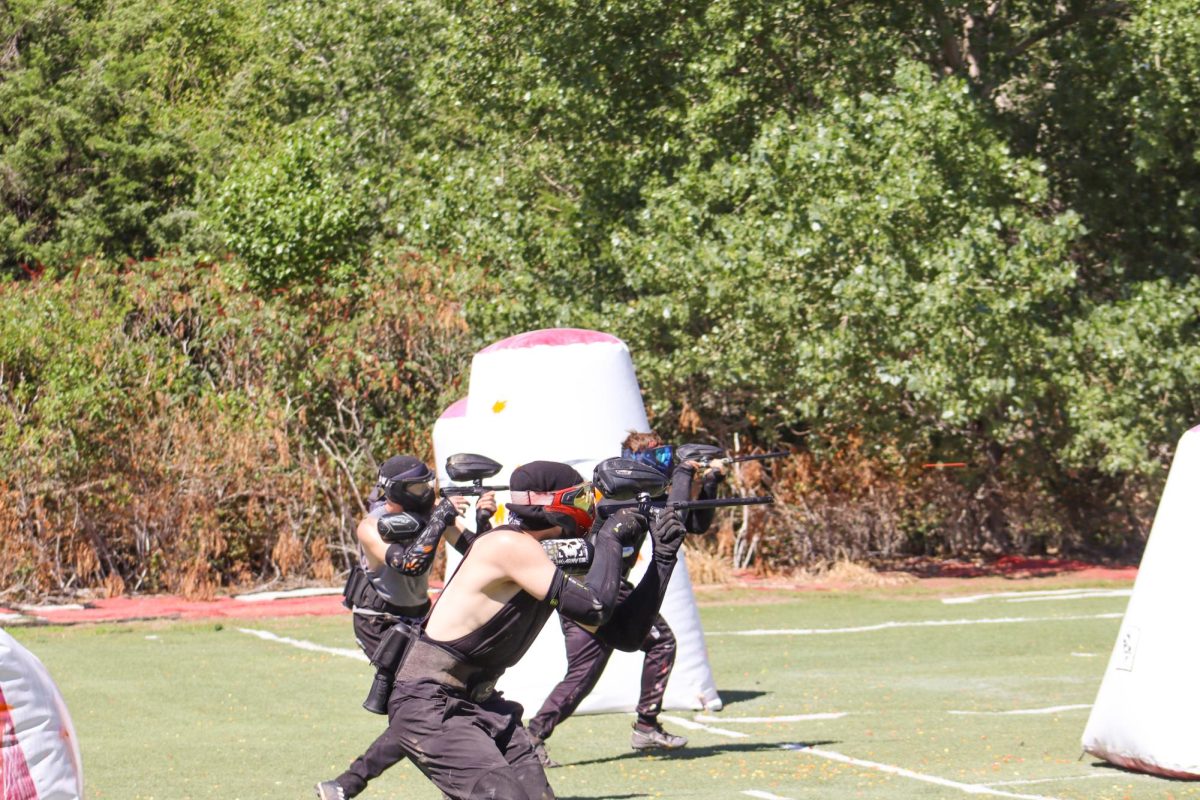 A group of Wichita State University paintball club members charge in at the start of a game. The club recently competed in the national championship tournament in April 2024.