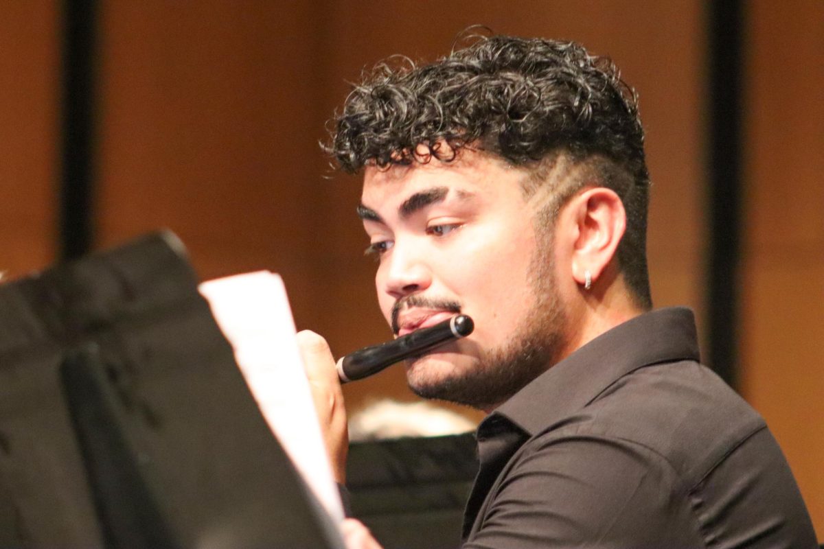 Graduate Jett Calderon, a member of the Class of 2023, plays the flute during the performance on Sept. 12. The ensemble presented five different pieces for its first performance of the year.