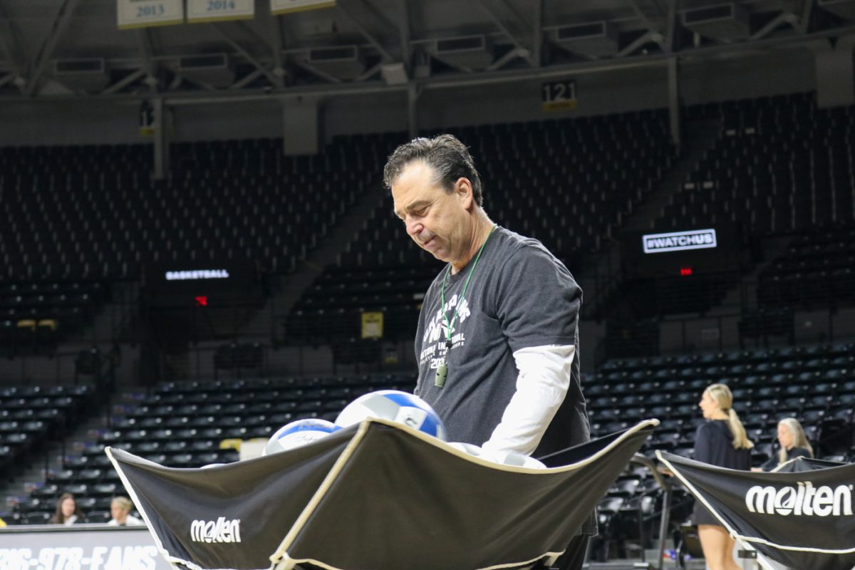 Wichita State volleyball head coach Chris Lamb runs practice on Sept. 18. Lamb said he gives the volleyball team a more difficult schedule for their development and RPI at the expense of winning less games.