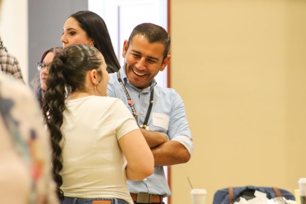 Fabián Armendáriz, Wichita Public Schools Director of Operations, spoke with a high school student during a statewide conference hosted by Wichita State University's HALO program on Sept. 16.