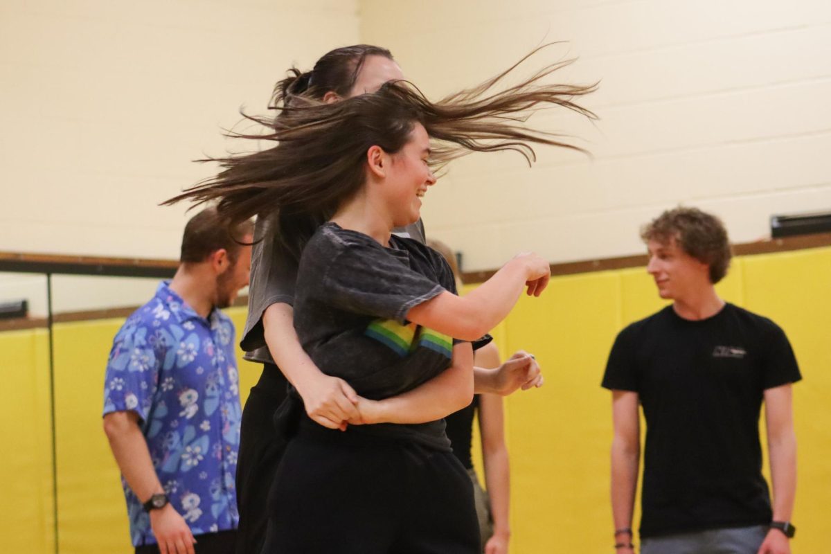 Senior Megan Castillo laughs while dancing with partner during a club meeting at the Heskett Center. The Westie Swing Club provided an opportunity to learn the West Coast Swing partner dance.