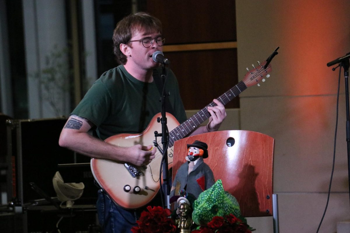 Kyle Hall, Petals band member and English graduate teaching assistant, performs at Mini Music Fest in the Rhatigan Student Center on Sept 20. Hosted by the Students Activity Council for the first time, the event featured live music, a DJ, food, and a vendor market.