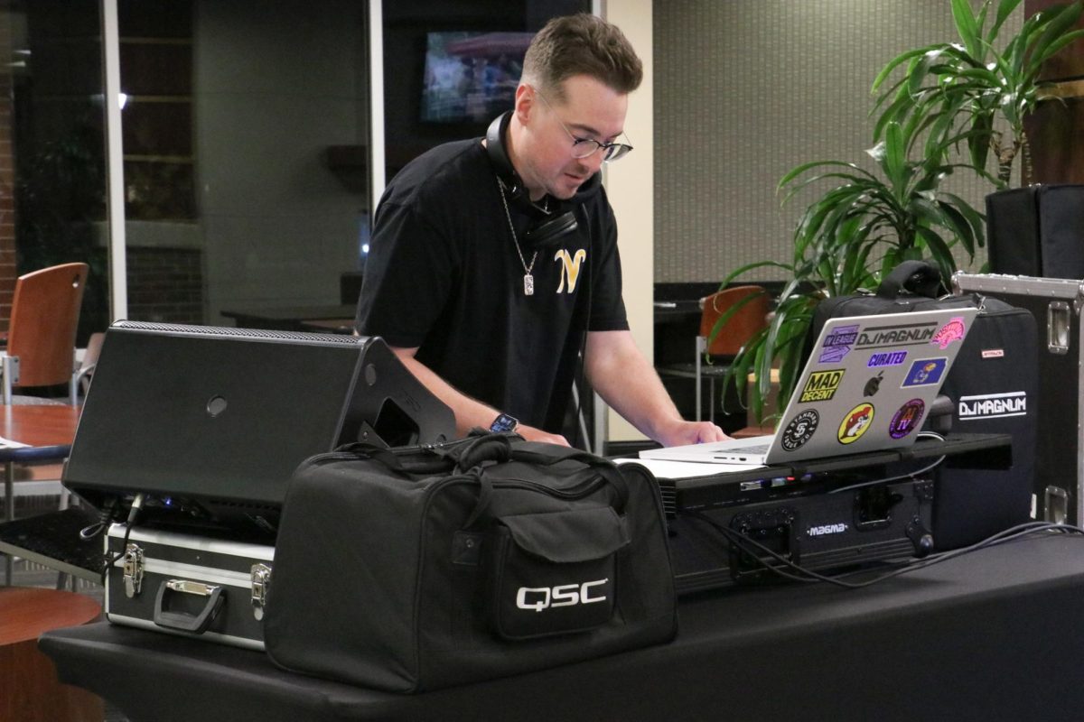 DJ Magnum, Tanner Goodrum, plays music between live performances at the Mini Music Fest in the Rhatigan Student Center on Sept. 20. Goodrum played remixes of popular music.