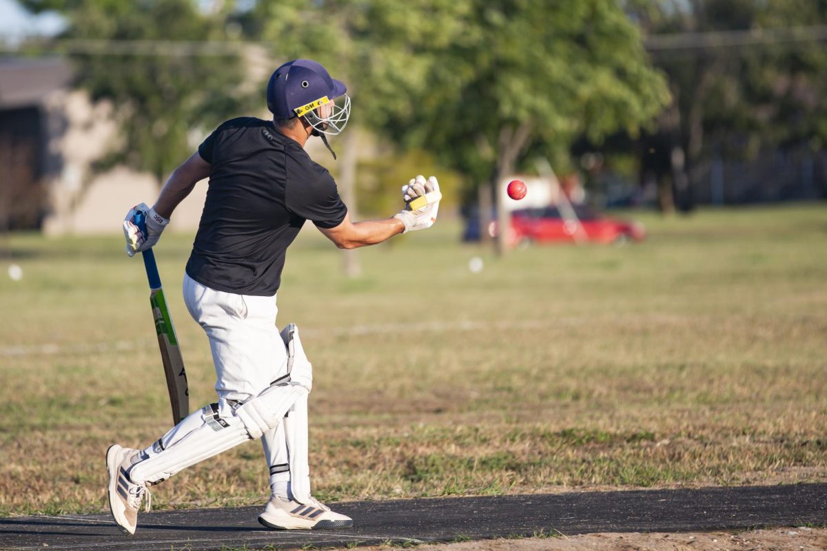 Kamran Hafeez tosses the ball back to the bowler during practice on Friday, Sept. 27. WSU's Cricket Club has more than 100 members.