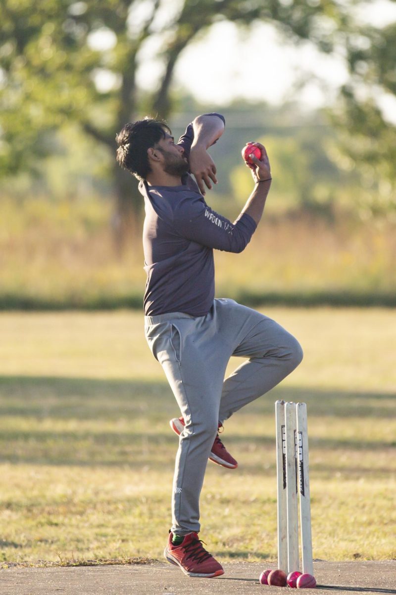 Virasut prepares to bowl the ball to the batter. Virasut is a fresh member of the Cricket Club team, attending his first practice on Sept. 27.