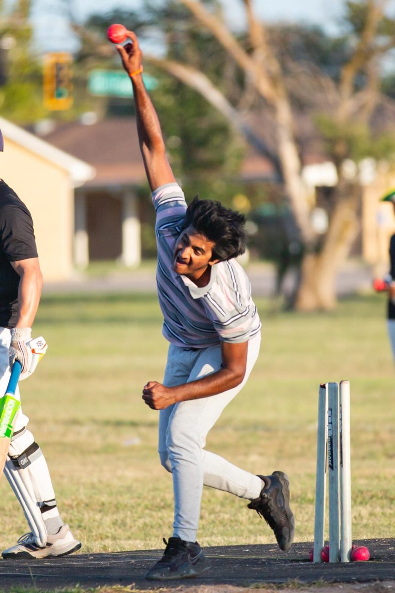 Satish Ankenapally bowls the ball toward a fellow teammate during practice on Sept. 27. The Cricket Club team played different tournaments throughout the month.