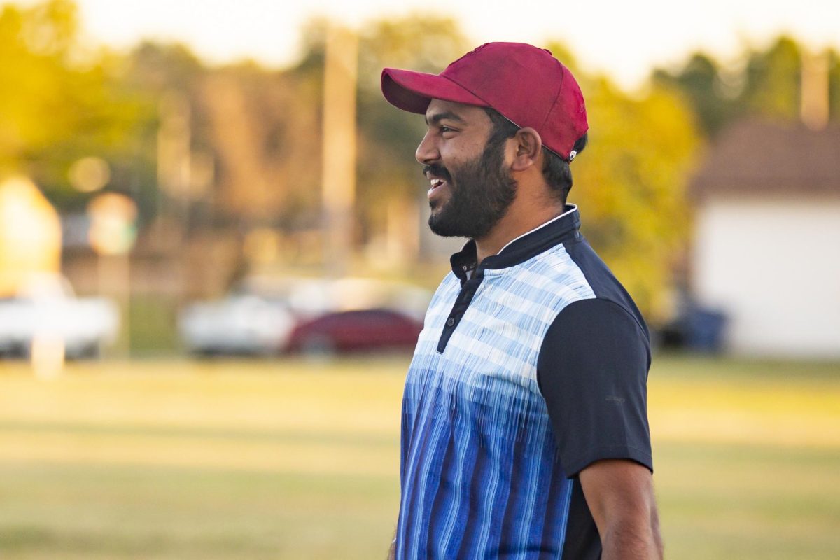 Sai Charan Reddy laughs after a play during a Cricket Club practice. 