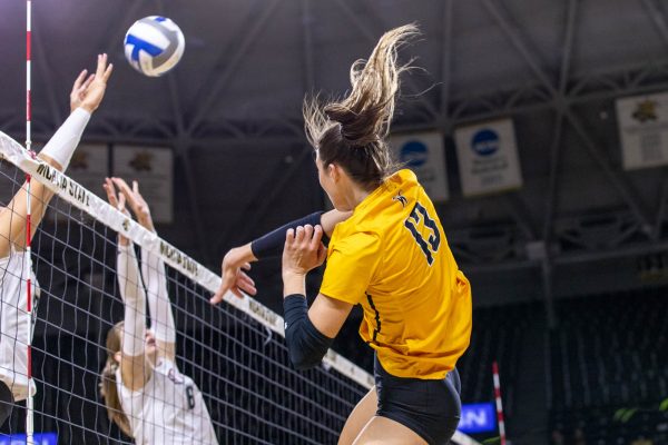 Junior outside hitter Emerson Wilford attempts a kill on Saturday afternoon against Omaha. The Shockers won a tight matchup, 3-2, as Wilford had 11 kills.