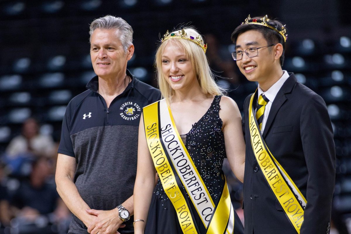 Riley McMillan and Matthew Phan pose with Rick Muma after being crowned Shocktoberfest Royalty.