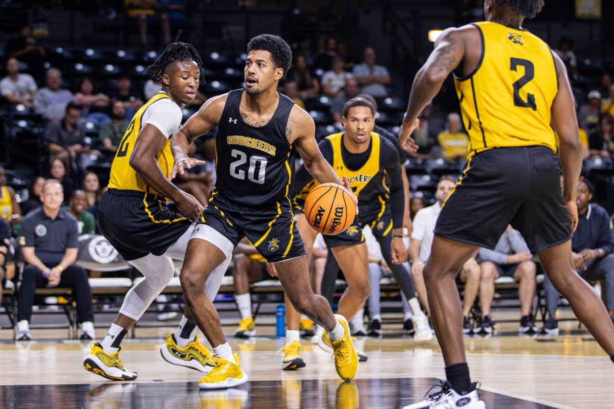 Harlond Beverly dribbles past defenders during an intrasquad scrimmage at Shocker Madness on Oct. 5. Beverly scored a team-high 10 points for the black team.