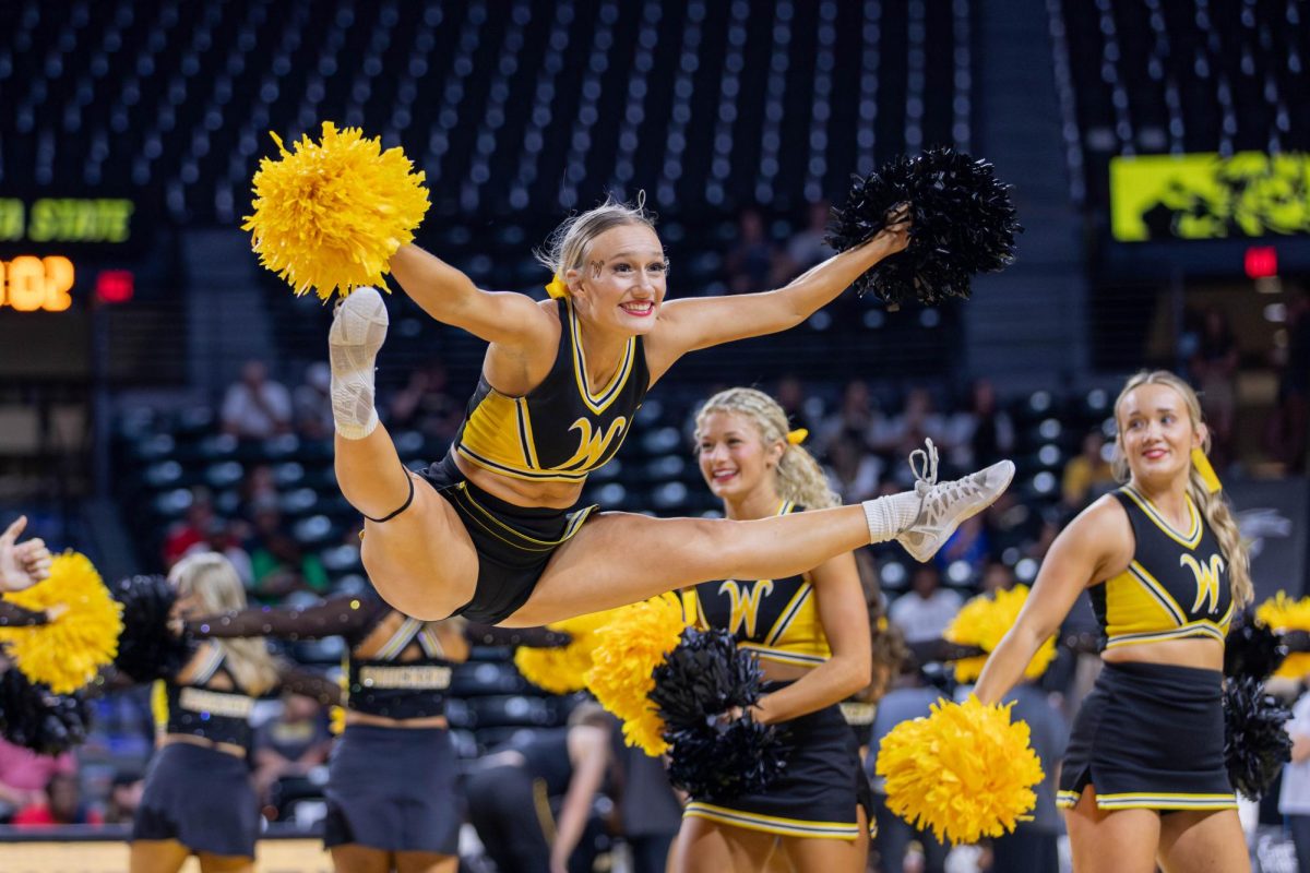 A Wichita State cheerleader jumps during a timeout in the men's scrimmage on Oct. 5. Shocker Madness closed out the week long events to celebrate Shocktoberfest.