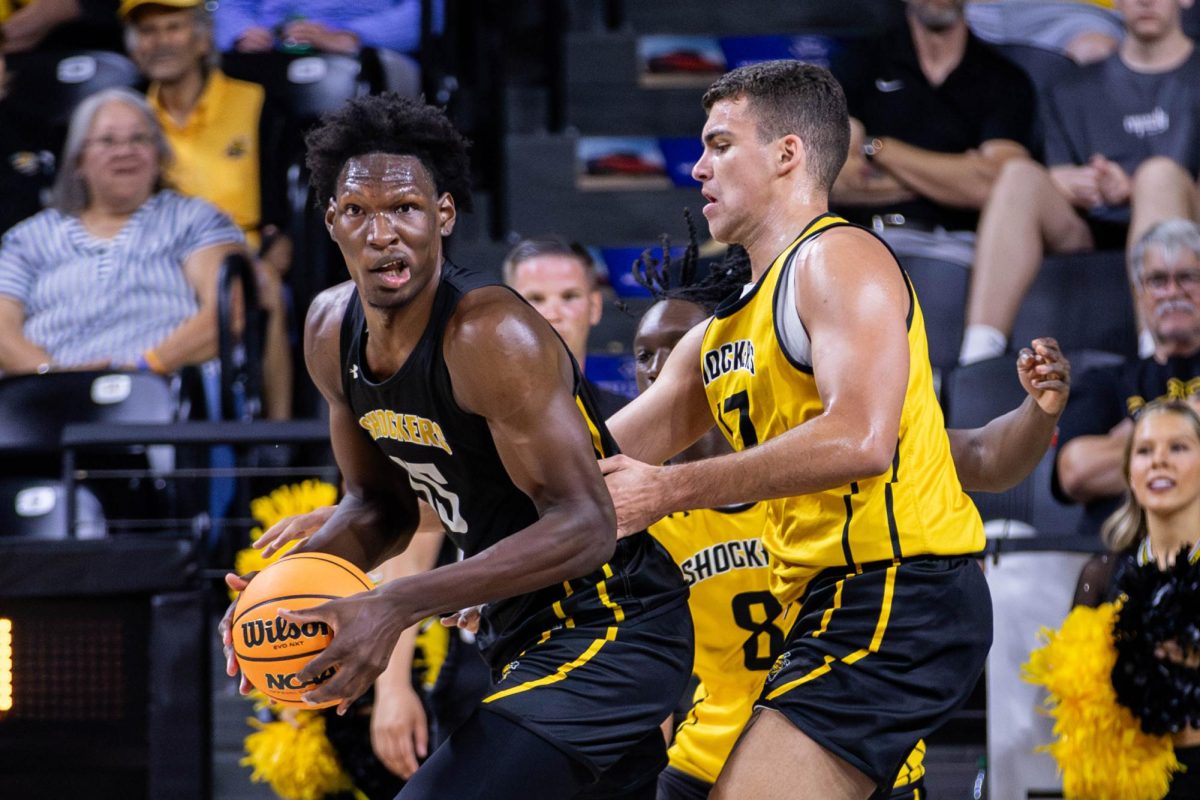 Quincy Ballard turns to pass the ball to a teammate during the Shocker Madness scrimmage. The men's basketball team had a 12 minute game at the end of the Oct. 5 event.