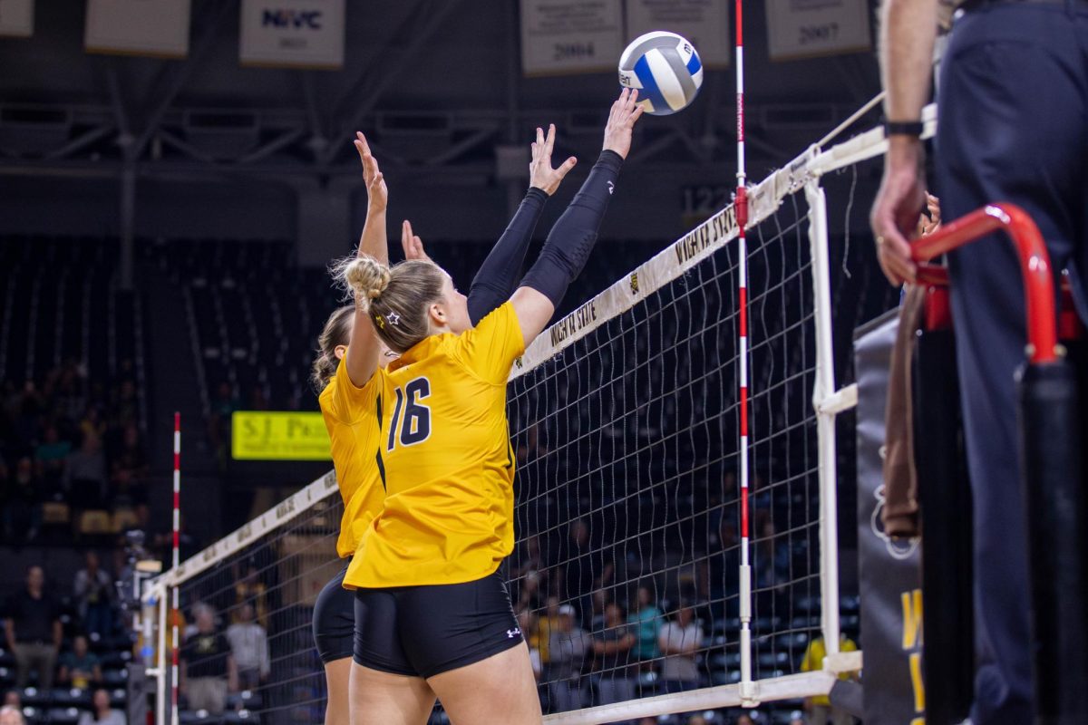 Morgan Stout and Izzi Strand jump to block the ball in the second set. The two players had a combined six blocks during the game.