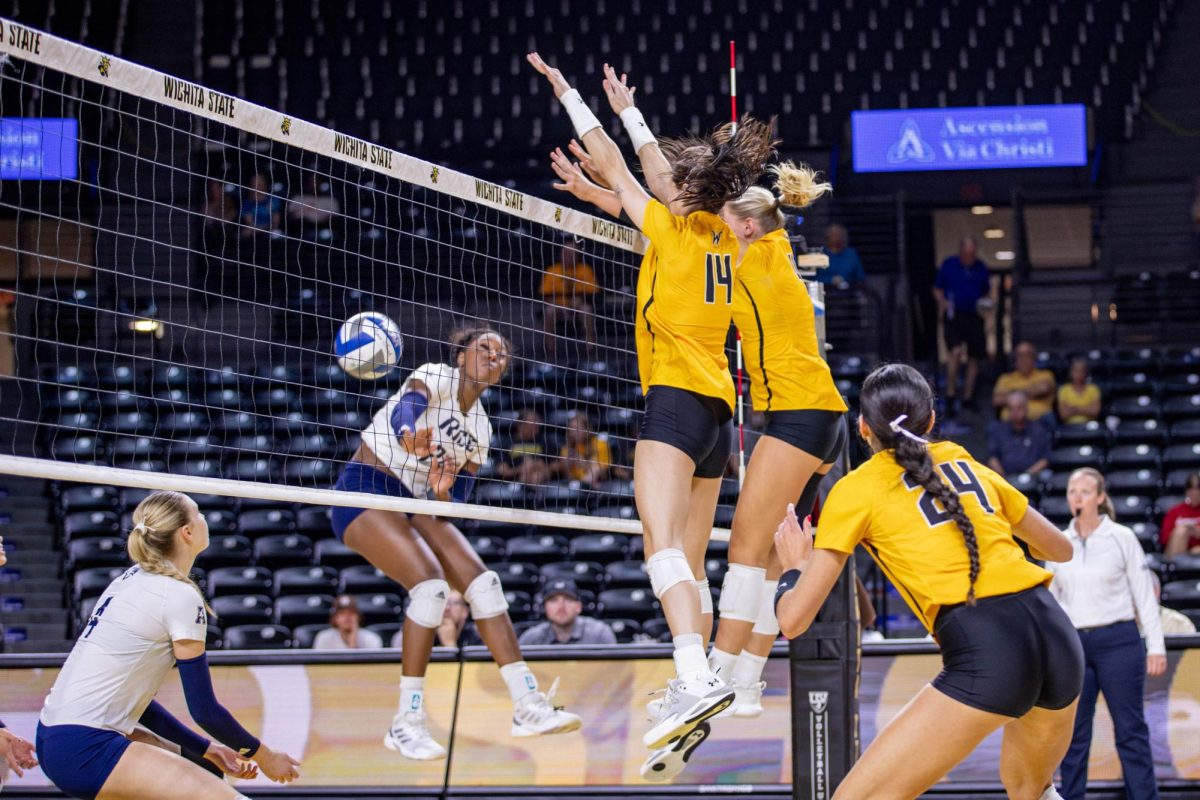 Maddie Wilson and Brooklyn Leggett block the ball from Rice in the third set. The two players had a combined 10 blocks during the game.