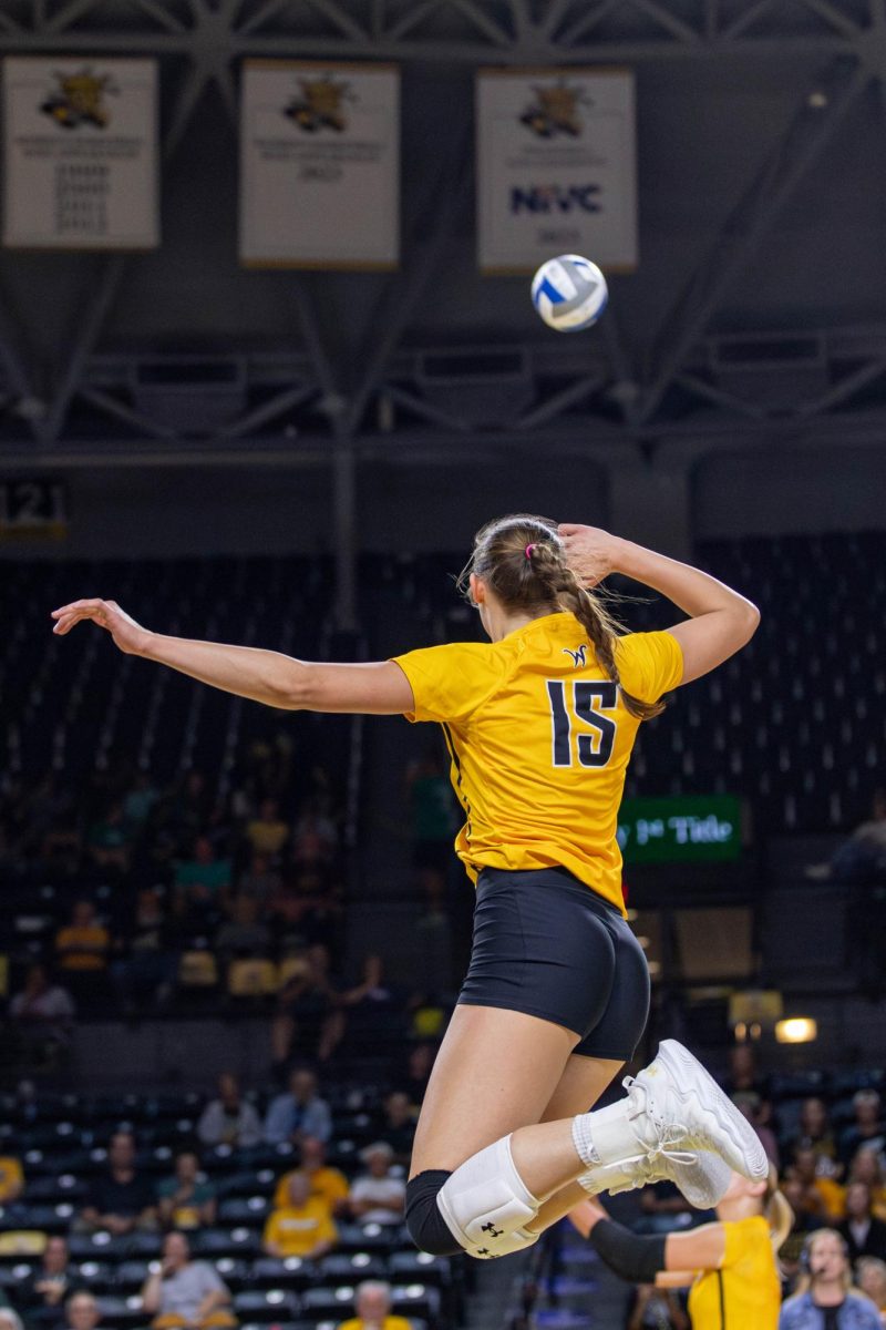 Morgan Stout jumps to fake a hit in the first set. Stout made 13 kills and three blocks during the game on Oct. 6.