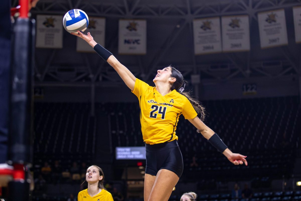 Alyssa Gonzales passes the ball over the net in the fifth set on Oct. 6. Gonzales scored 14.5 points against Rice and made 13 kills.