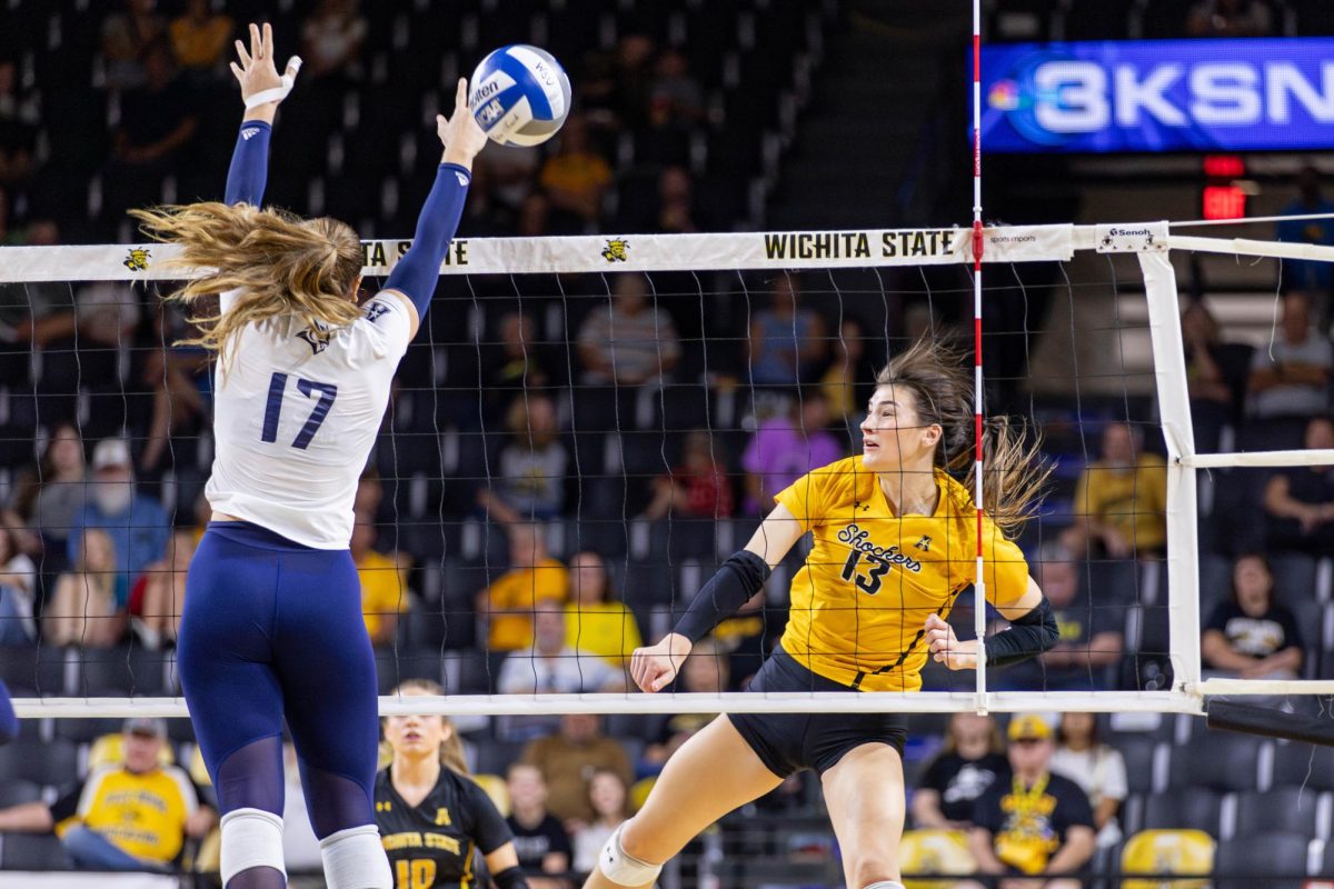 Emerson Wilford hits the ball past the Rice defenders on Oct. 6. Wilford, a junior, scored 10 kills and three blocks during the game.