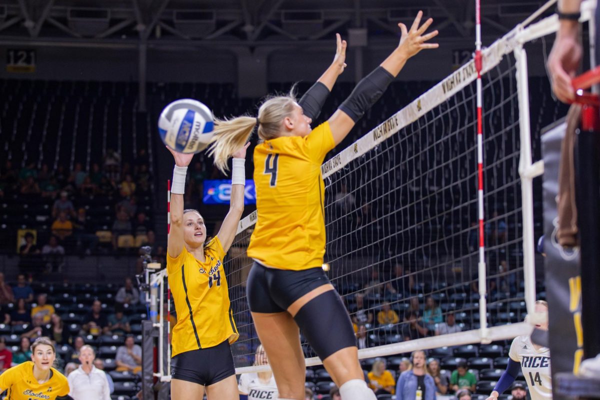 Maddie Wilson and Brooklyn Leggett jump and try to block the ball. Leggett made three blocks during the game against Rice.