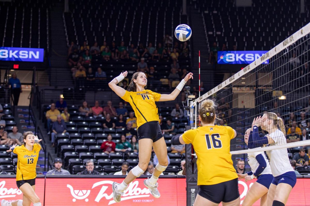 Maddie Wilson jumps to hit the ball over the net in the second set. Wilson had nine kills and seven blocks during the game against Rice.