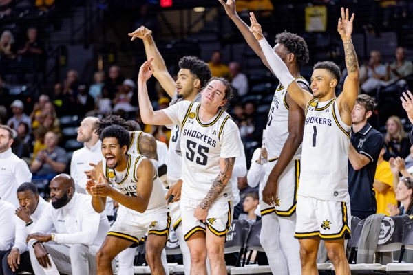 Wichita State bench players celebrate a 3-pointer in the second half against Emporia State. The Shockers shot 40% from the 3-point line on Oct. 27.