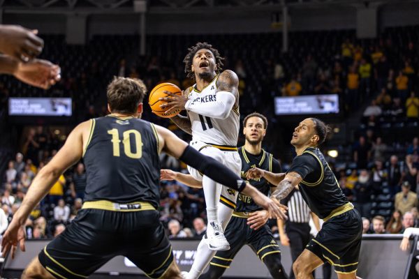 Justin Hill jumps past the Emporia State defense on Oct. 27. Hill scored four points during his 14 minutes of play time.