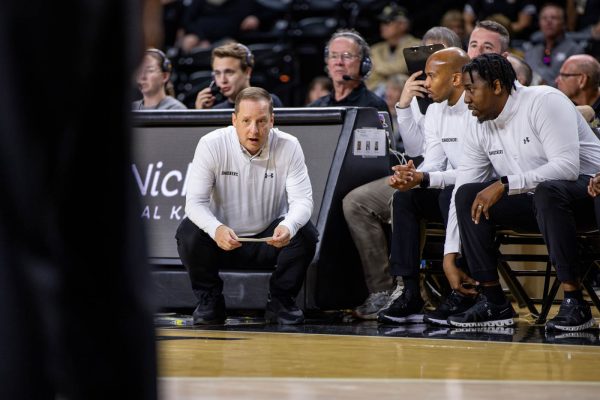 Head Coach Paul Mills talks to the Wichita State assistant coaches during the second half on Oct. 27. Mills is in his second season with Wichita State.