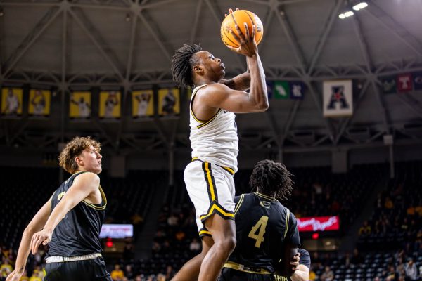 Zion Pipkin, a freshman, jumps to shoot a basket in the second half. Pipkin scored nine points during his 15 minutes of play time on Oct. 27.