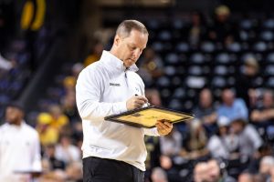 Head coach Paul Mills writes on a white board during a time out in the second half. Wichita State beat Emporia State during the exhibition game, 99-53, on Oct. 27.