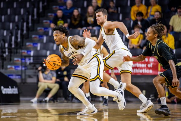 Justin Hill, a guard, runs down the court against Emporia State on Oct. 27. Hill scored four points during his 14 minutes of play time.