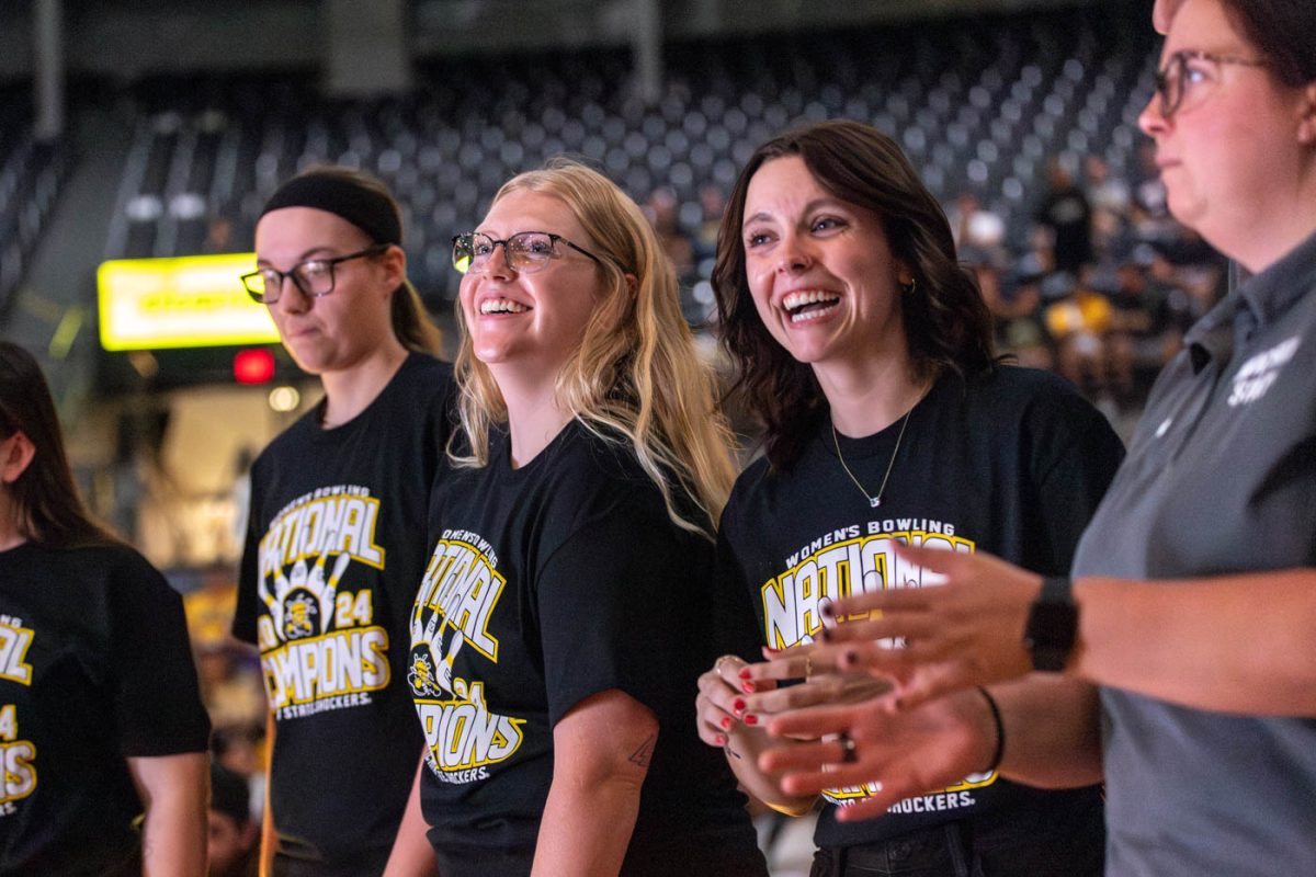 Brooklyn Gagnon and Piper Reams laugh as they watch the bowling team's hype video on Oct. 5. The two seniors were a part of the 2024 national winning team, which recieved their rings at Shocker Madness.