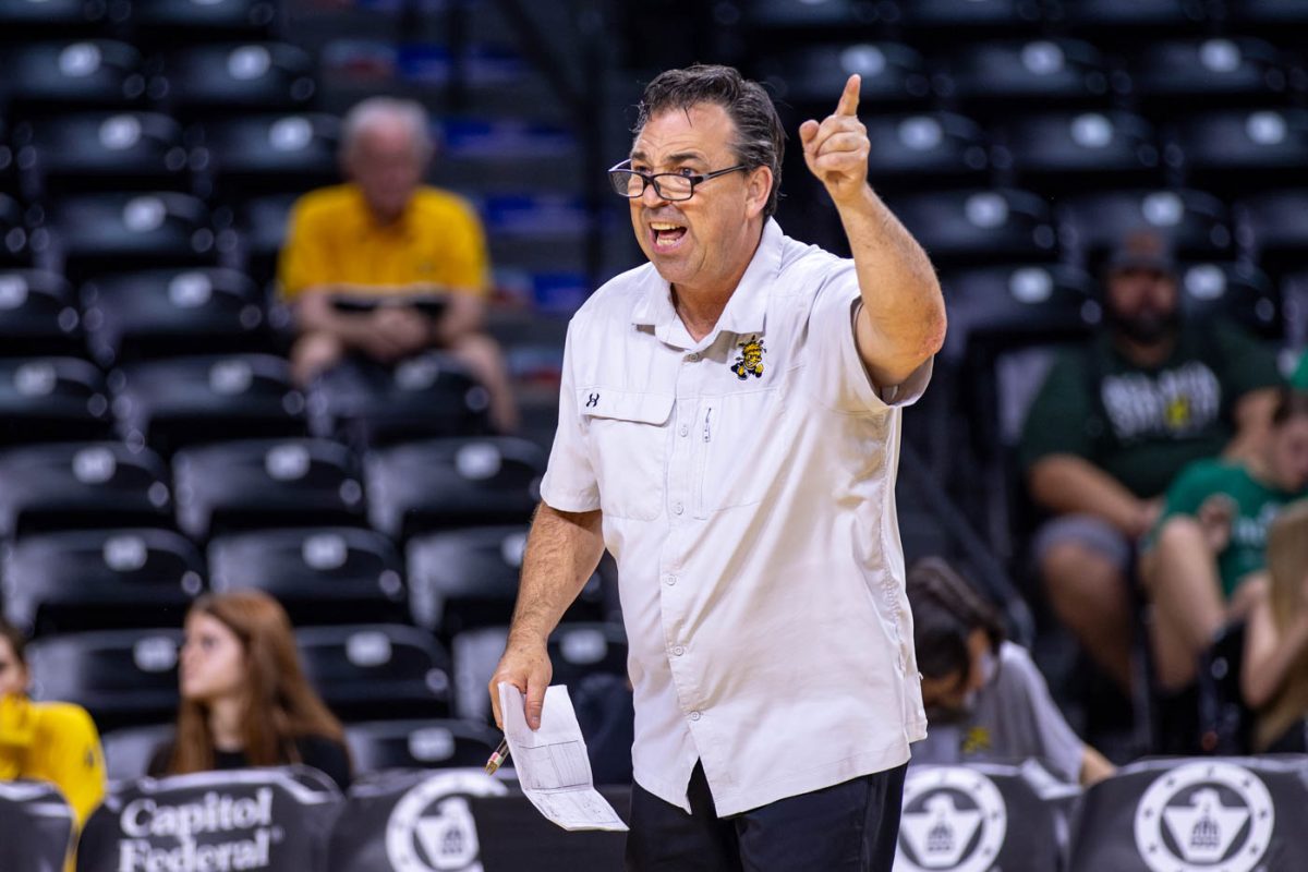 WSU head coach Chris Lamb yells to the players during the fourth set on Oct. 6. Wichita State fell to Rice, 3-2, on Sunday afternoon.