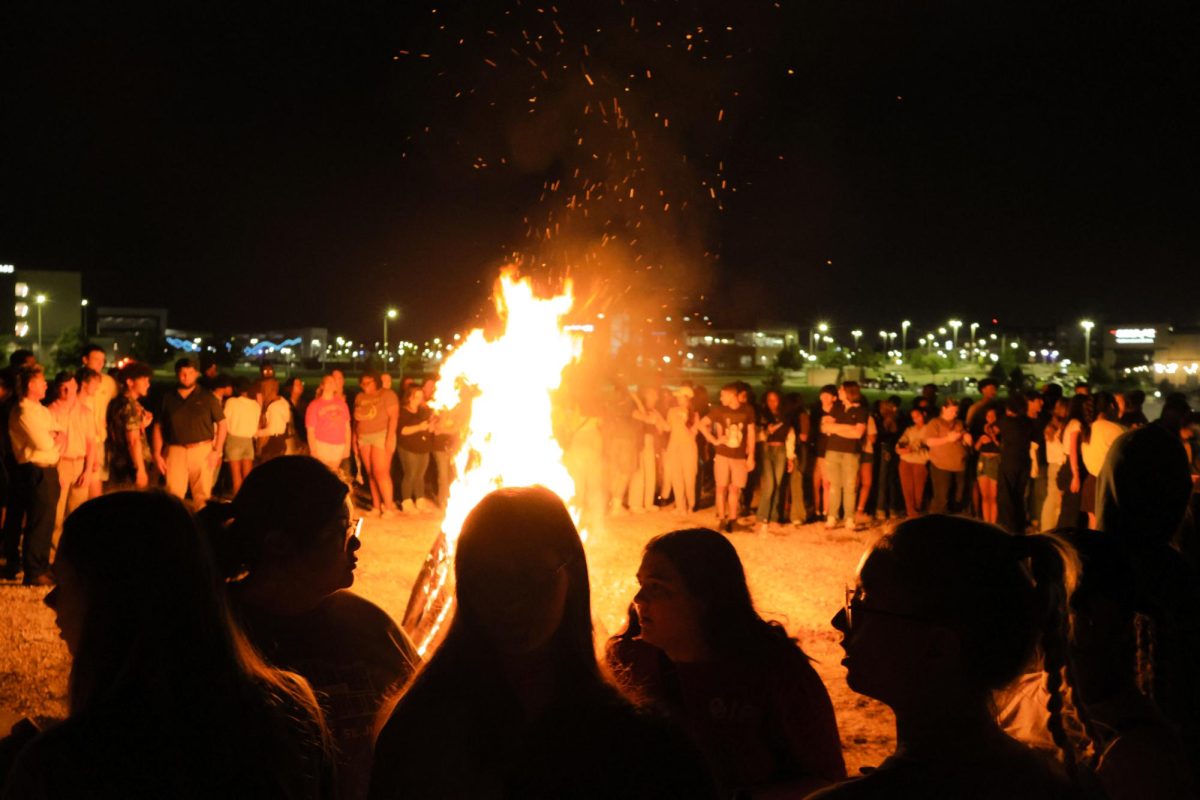 WSU students gather around bonfire to kick off Shocktoberfest on Sept. 30. Shocktoberfest will be held until Oct. 5 this year and will include events centered around spirit and pride throughout the Wichita State campus.