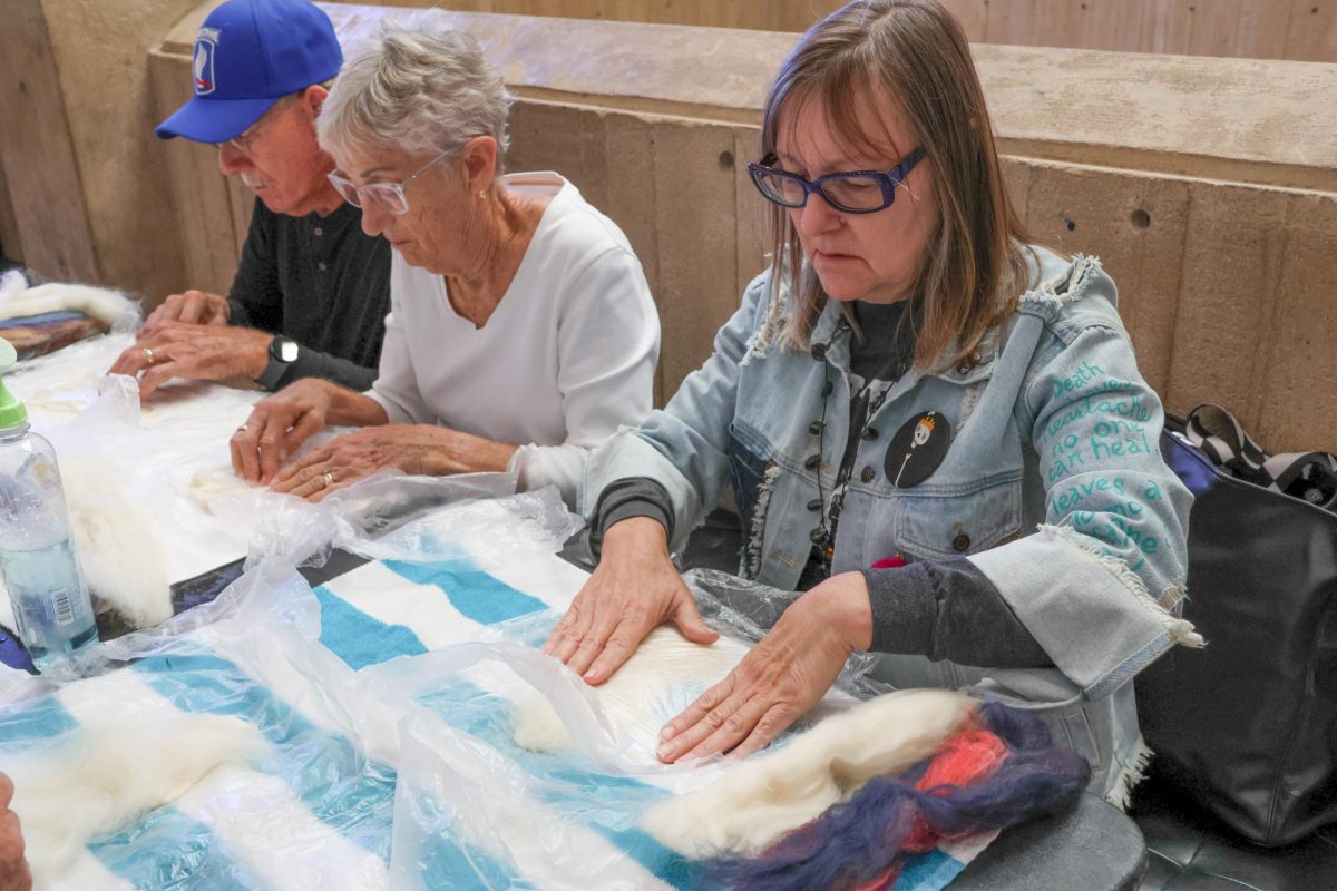 Event attendee Janice Meinhart smooths out her felt. The "Felting the Figure" event was instructed by Ernie Kind at the Ulrich Museum of Art on Oct. 16.