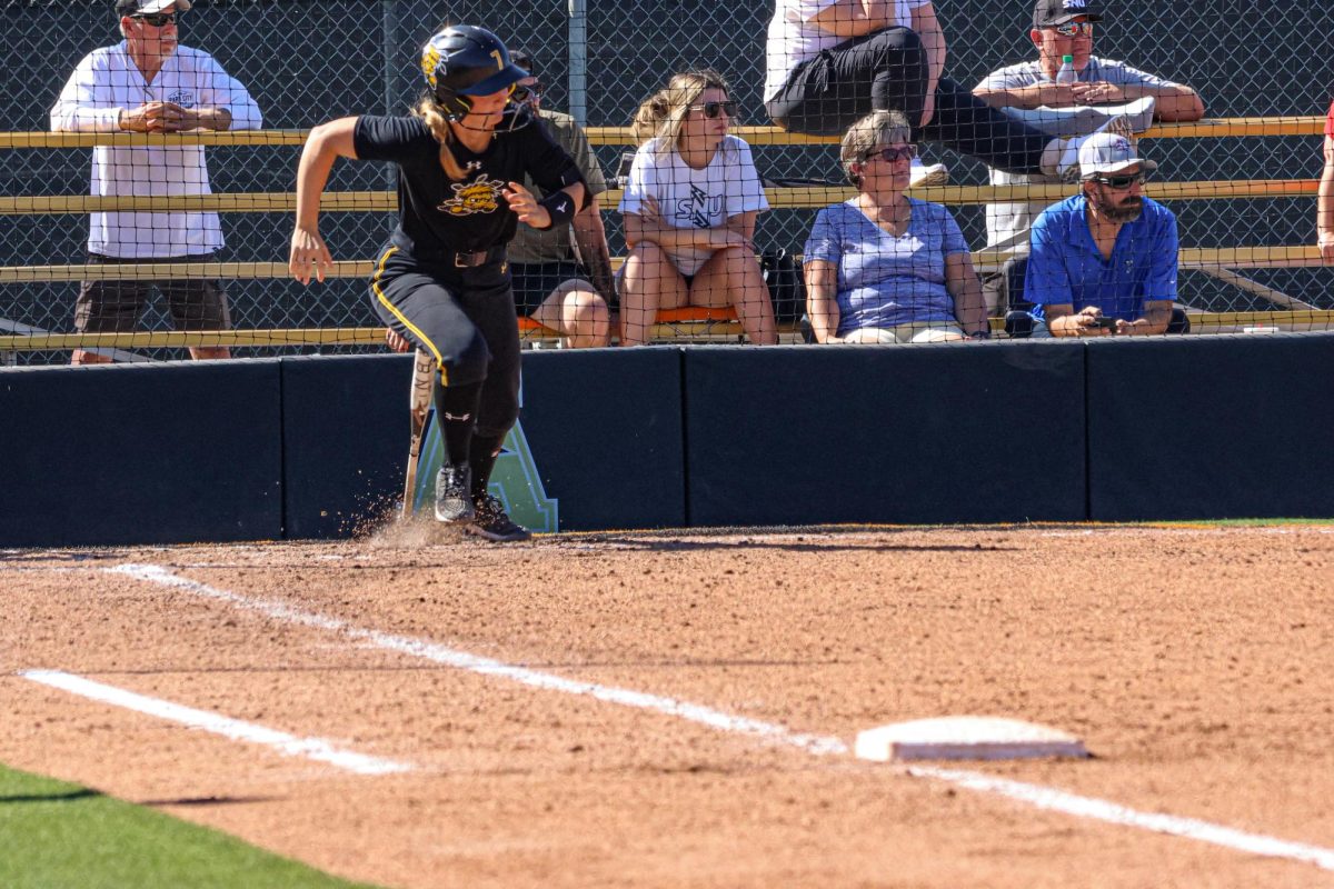 Freshman Catelyn Beckerley gets her feet up as she runs to first base on Oct. 5. As a true freshman, Beckerley is coming off a senior season in high school where she hit .405.