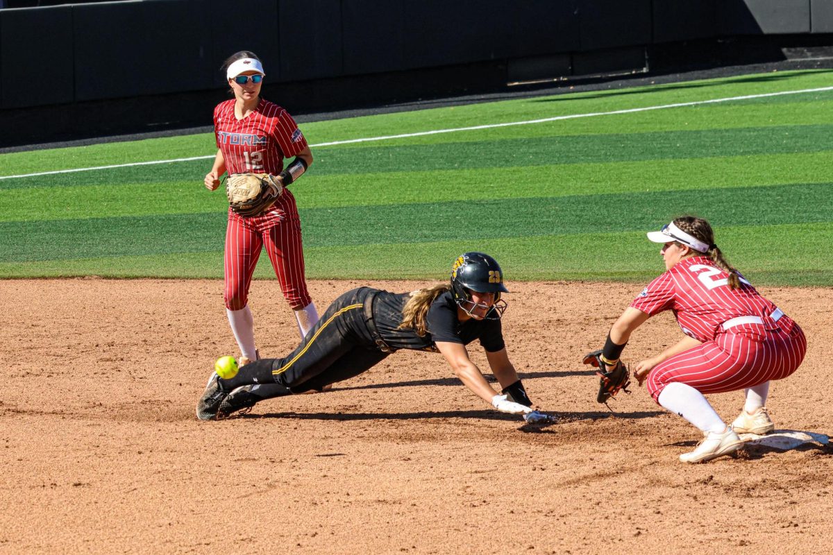 Junior Taylor Sedlacek dives toward second base on a pickoff attempt. Last year, Sedlacek started all 50 games for the Shockers and earned a spot on the American Athletic Conference All-Academic Team.