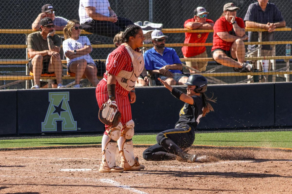 Junior Jodie Epperson slides into home plate on Oct. 5. A utility player new to WSU softball this year, Epperson played two years for North Texas.