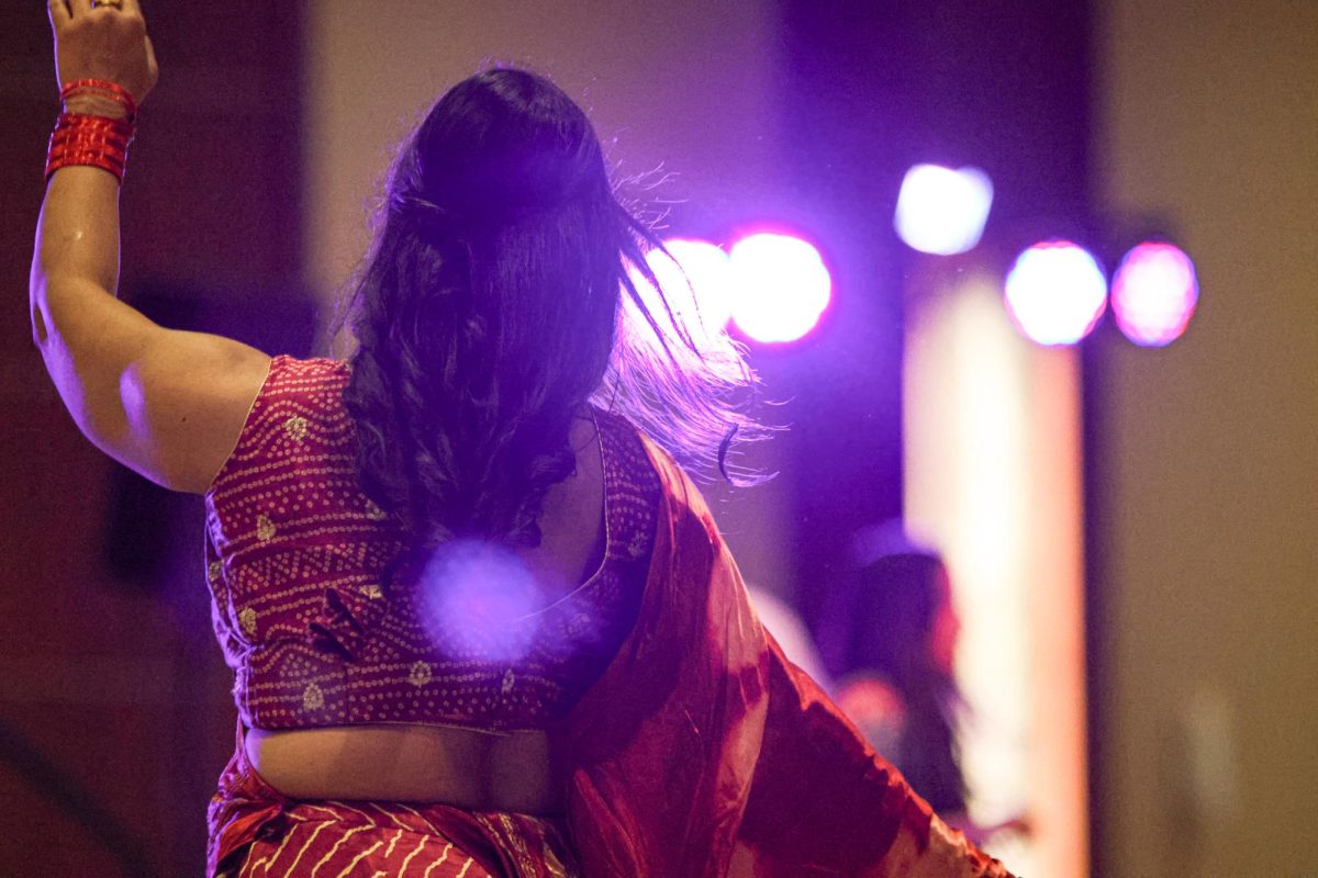 A community member dances during the Garba Night celebration. Garba is a traditional circular dance performed to rhythmic music, symbolizing unity and devotion, and celebrates the rich cultural traditions of Gujarat.