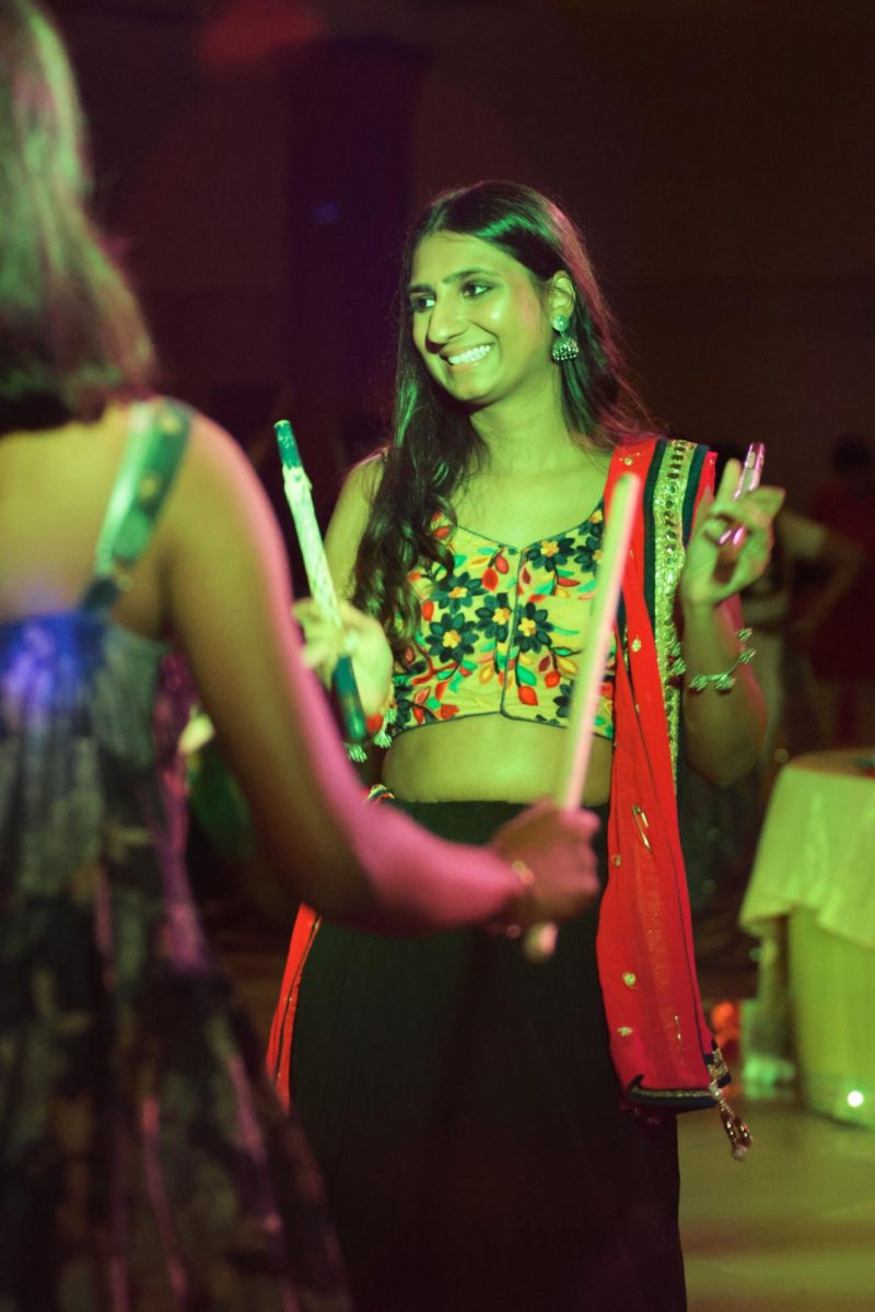 Sajani Bhakta shows amusement during the Dandiya Raas dance. Dandiya Raas is danced in a festive spirit to celebrate life, love, and devotion, with its roots in both religion and community joy.