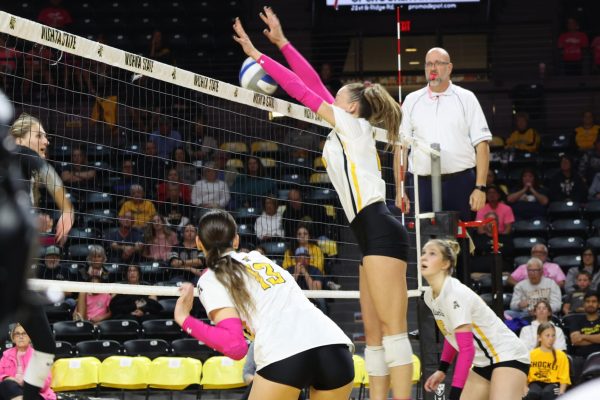 Senior middle blocker Morgan Stout blocks the ball on Oct. 25 against Memphis. Stout finished with 10 blocks and 18 kills in the game.