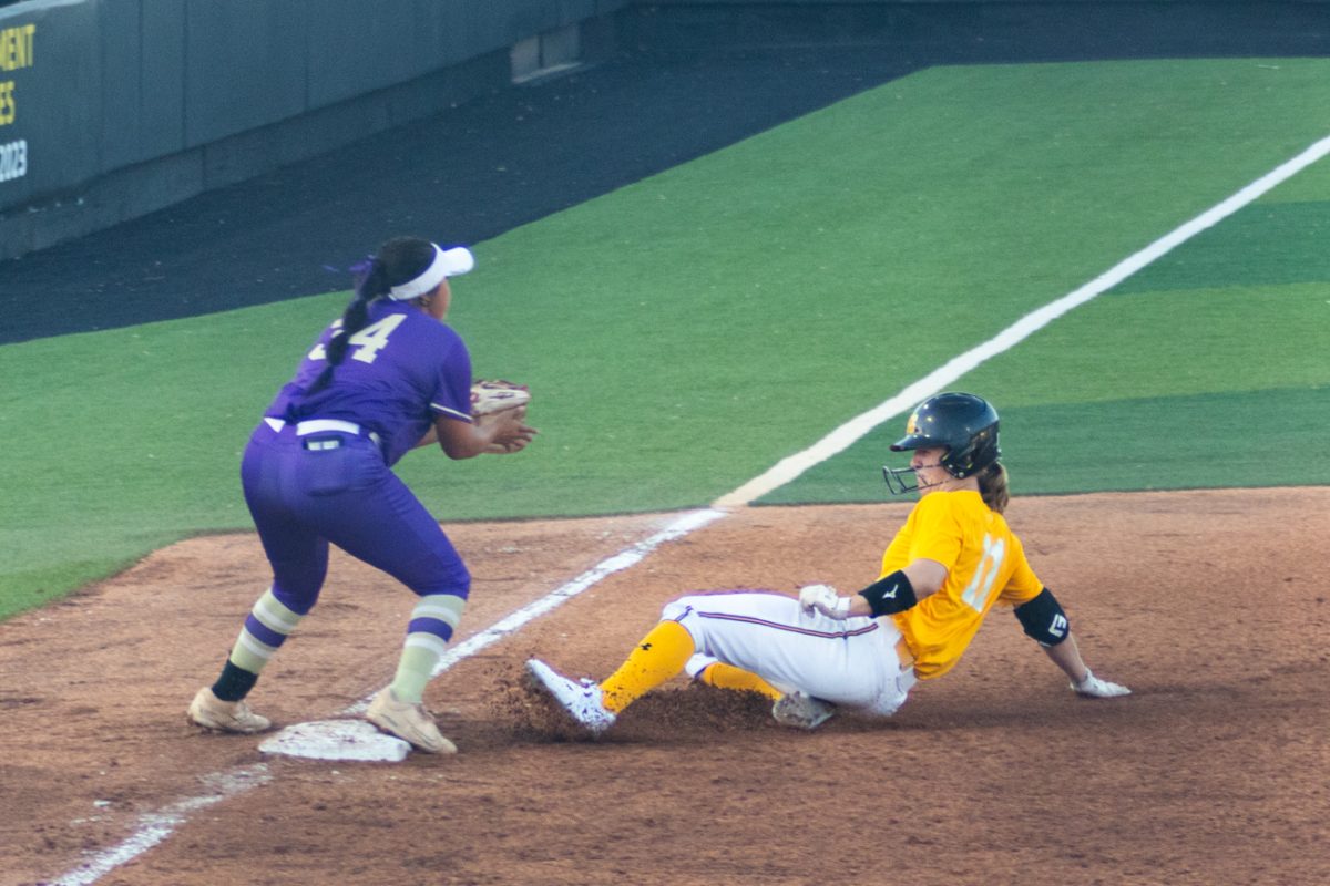 Graduate Student Ellee Eck slides in to third base during the exhibition game against Butler Community College on Oct. 3. Eck previously played for Standford University, appearing in the 2023 and 2024 Womens College Softball World Series.