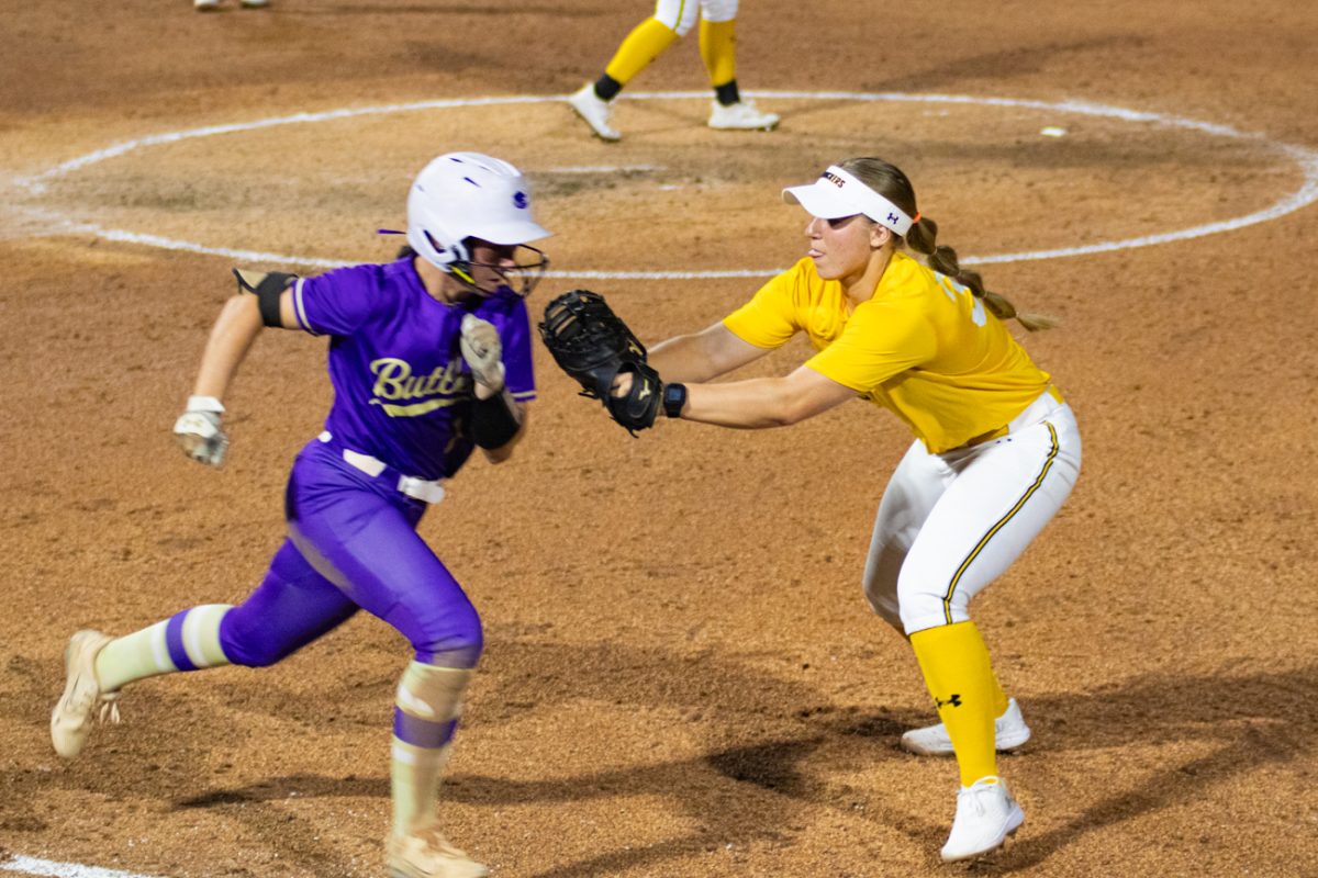 Senior Caroline Tallent reaches to tag a runner out at first. Last season, Tallent set a new single season record for the university with 16 hit by pitches.