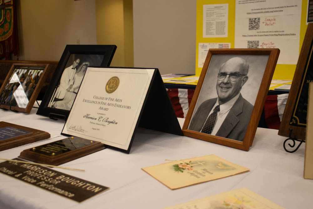 A memorial table adorned with photos, awards and other mementos of Harrison "Bud" Boughton is displayed at the Holy Cross Lutheran Church. Boughton was the adult choir director at the church and a professor of music at Wichita State for nearly four decades.