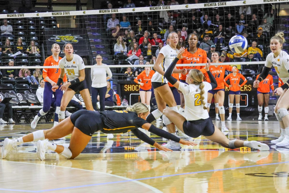 Junior Katie Galligan dives for the ball as it goes through freshman Gracie Morrow's hands on Nov. 17. Wichita State volleyball fell to UTSA, 3-1.