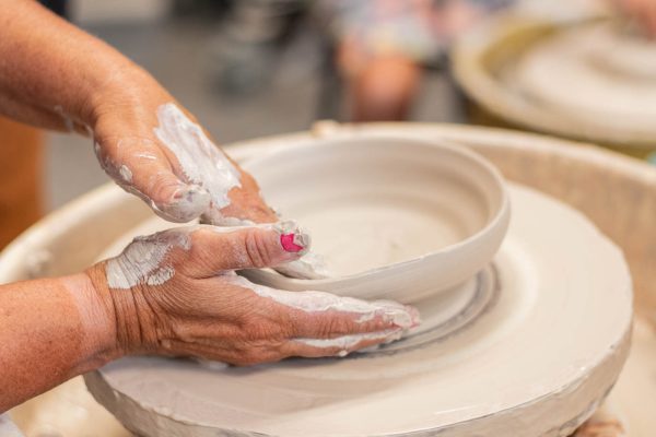 Cindy Walthers creates her own bowl at Build-A-Bowl on Sept. 7, Ceramic Guild's recent event. During Nov. 19-22, the Ceramic Guild allowed for community members to engage in another immersive art experience at the Holiday Sale, where local artists showcased ceramic pieces for sale. 