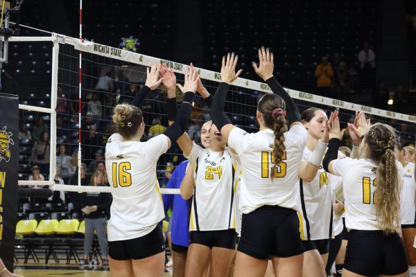 Wichita State volleyball players celebrate after beating the University of Tulsa on Sunday afternoon, 3-1. The win was Wichita State's second against the Golden Hurricane this weekend.