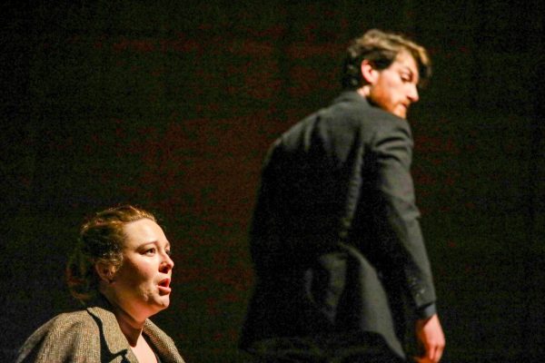 Wichita State assistant professor Hilary Grace Taylor sings to the audience as Logan Tarwater listens during the opera, "December Night," on Dec. 8. The opera's libretto was based from a chapter of the novel "Death Comes for the Archbishop" by Willa Cather. 