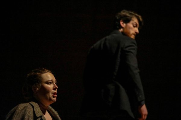 Wichita State assistant professor Hilary Grace Taylor sings to the audience as Logan Tarwater listens during the opera, "December Night", on Dec. 8. The opera's libretto was based from a chapter of the novel "Death Comes for the Archbishop" by Willa Cather. 