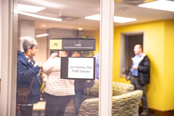 Faculty mingle at the open house for the new Faculty Advancement, Retention and Excellence office. The office was created to focus on helping Wichita State Faculty advance professionally.