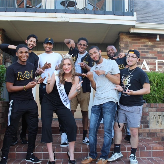 A winner of the Miss Black and Gold Scholarship Pageant poses with Alpha Phi Alpha fraternity members. | Photo courtesy of AJ Haynes 